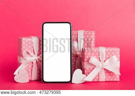 Mobile Phone With Blank Screen On Colored Background With Hearts, Calendar And Gift Box, Valentine D