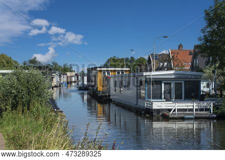 Houseboats On The Braakslot Canal In Zaandam District Kalf. Province Of North Holland In The Netherl