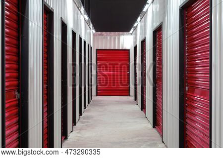 Corridor Of Self Storage Unit With Red Doors. Rental Storage Units