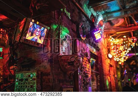 Interior Of Szimpla Kert, Famous Ruin Pub In Budapest At Night. Old Computer Screens On The Walls. N