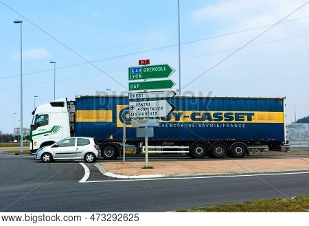 Valence, France - March 3, 2023: A Truck And A Car In Front Of The Roundabout In Valence. Road Signs