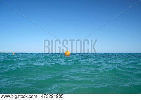 Yellow Buoy Floating On Sea Surface As Marker For Swimming Restriction In Deep Water At Tropical Res