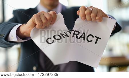 Businessman In Suit Tearing Paper Document Contract At Work In Office Closeup. Broken Or Breached Co