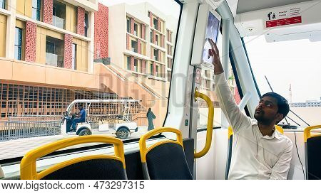Uae, Abu Dhabi - 13th March, 2023: Person Sets Route On Screen To Drive In In Masdar City Campus. Na