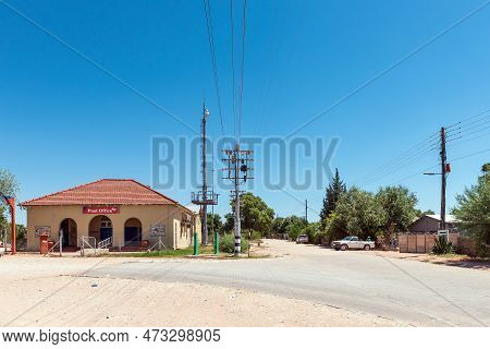 Groblershoop, South Africa - Feb 24, 2023: A Street Scene, With The Post Office, People And Vehicles