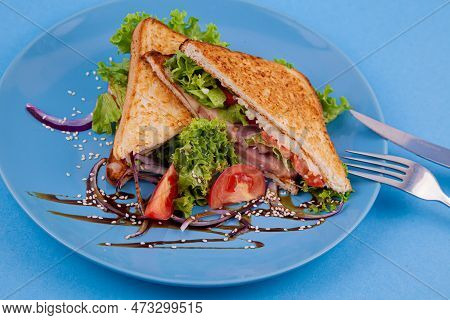 Breakfast Sandwich Toast With Salad. Blue Background. Bread, Beakon Tomatoe On Plate Top View. Meat 