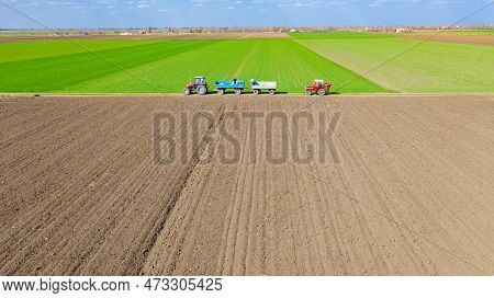 Above View Two Farmers As Reloading Artificial Fertilizer From Trailer, Full Of Stuffed Sacks With C