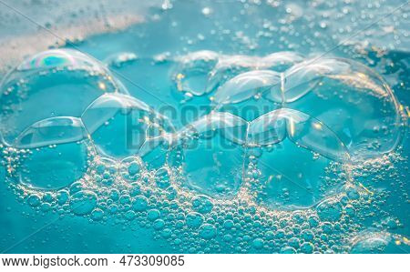 Texture Of Soap Bubbles In Close Up. Bubble Bath. Gel For Washing Or Washing Hands.blue Background W