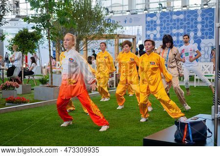 Moscow, Russia - January 5, 2020: Social Innovation Exhibition. Group Of People Doing Qigong Exercis