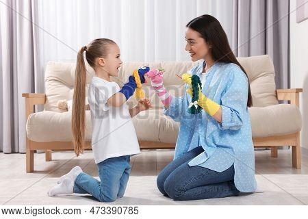 Happy Mother And Daughter Playing With Funny Sock Puppets Together At Home