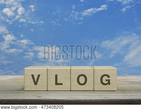 Vlog Letter On Wood Block Cubes On Wooden Table Over Blue Sky With White Clouds, Vlog Video Marketin