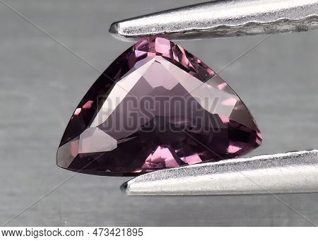 Natural Gem Purple Sapphire On Gray Background