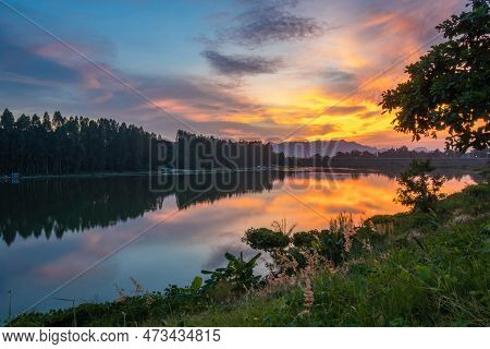 Beautiful View Of Twilight Silhouette Sunset On The Water Reservoir While The Sky After Sunset Has O