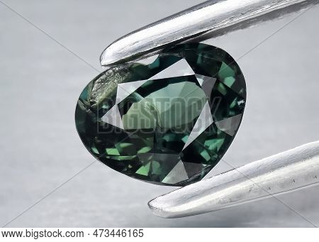 Natural Gemstone Green Sapphire On Gray Background