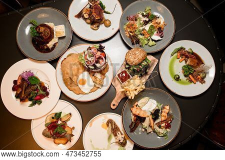 Top View Of Plates With Different Dishes On Table