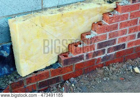Insulating Walls Of New Build Houses By Placing Rock Wool Inside Wall Cavities As Part Of The Energy