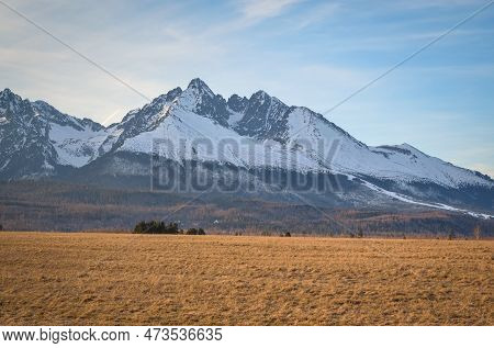 Beautiful, Mountainous, Spring Panorama. White Snow-covered Peak In The Slovak Tatra Mountains. Phot