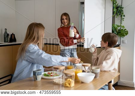 Family Meal Time. Single Mother And Two Kids Eating In Kitchen At Home, Spending Quality Time Togeth