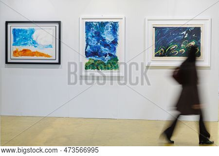 Parma, Italy - October 2022: Girl Walking And Admiring Paintings In A Modern Art Gallery.