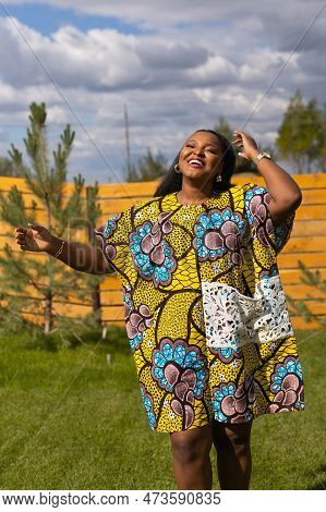 Portrait Of Beautiful African American Woman Having Fun On Village Or Suburbian. Outdoor Portrait Of