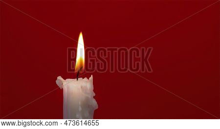 Banner Size Image Of Burning Candle Against A Red Background With Free Copy Space For Text