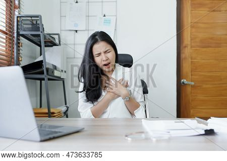Portrait Of Young Asian Female Representative Showing Acute Chest Pain From Sitting For A Long Time 