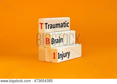 Tbi Traumatic Brain Injury Symbol. Concept Words Tbi Traumatic Brain Injury On Wooden Blocks On A Be