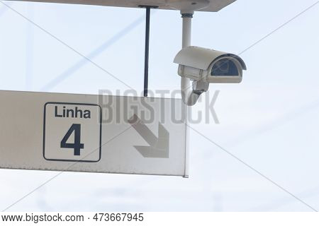 Security Cctv Camera And A Sign Pointing To The Way On Linha