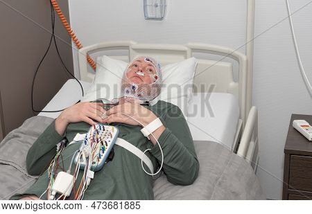 Middle Aged Woman Measuring Brain Waves, Examining Polysomnography In Sleep Lab
