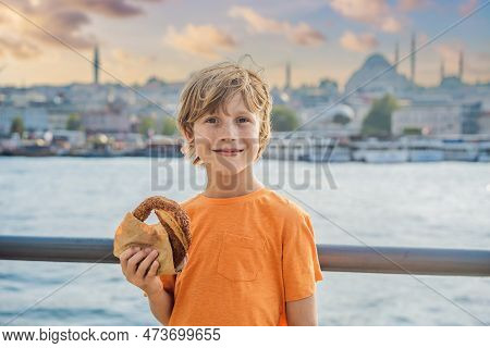 Boy In Istanbul Having Breakfast With Simit And A Glass Of Turkish Tea. Glass Of Turkish Tea And Bag