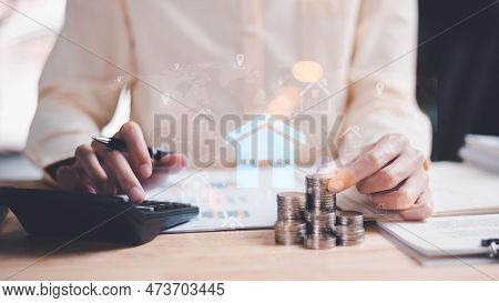 Man Holding Coin And Use Calculator To Calculate Interest Rate,real Estate Business,appraisal Of Pro