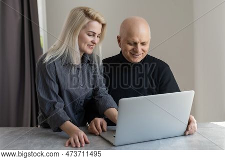 Smiling Mature Elderly Man Financial Documents And Laptop, Questionnairewith