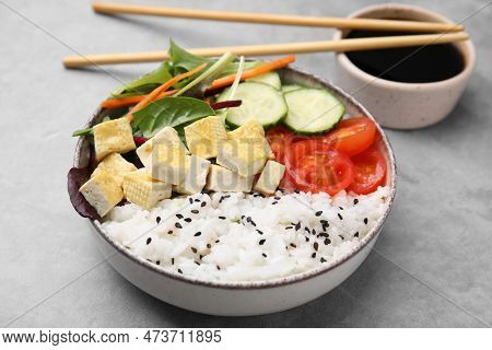 Delicious Poke Bowl With Vegetables, Tofu And Mesclun Served On Light Grey Table, Closeup