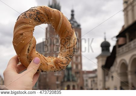Tourist Woman Eating Bagel Obwarzanek Traditional Polish Cuisine Snack Waling On Market Square St. M