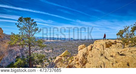 Woman Standing On Top Of Sandstone Formations At El Malpais National Monument, New Mexico.