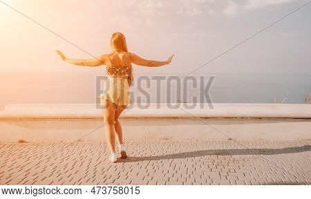 Woman Summer Dance. Silhouette Of A Happy Woman Who Dances, Spins And Raises Her Hands To The Sky. A