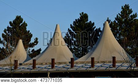 White Tarpaulin Taut, Shading From The Sun And Rain Over The Terrace Of The Restaurant, On The Playg