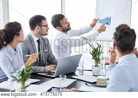 Young Busnessman Having A Speech With A Finance Graph During A Conference Business Meeting In An Off