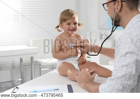 Pediatrician Examining Baby With Stethoscope In Clinic