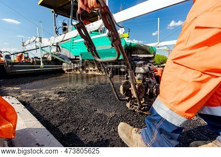 View On Worker Who Is Compacting Asphalt With Vibration Plate, Compactor Machine On The Bridge Under