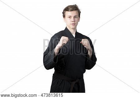Taekwando.a Teenager In A Black Kimano Who Is Engaged In Taekwando.