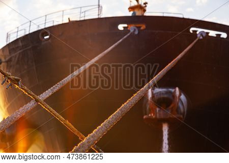 Stretched Mooring Lines From The Cargo Ship. Moored Cargo Ship.