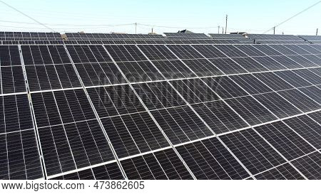 Solar Power Plant. Flight Over Modules Of Solar Power Station On Sunny Day. Renewable Electrical Ene
