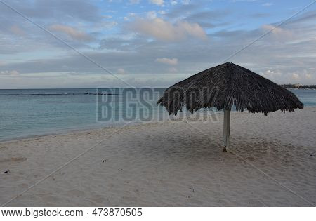 Grass Beach Hut On A White Sand Beach In Aruba.