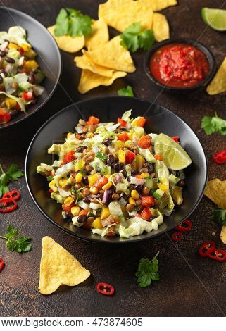 Mexican Style Salad Of Black Beans, Lentils, Corn, Tomato And Lettuce With A Salsa And Tortilla Chip