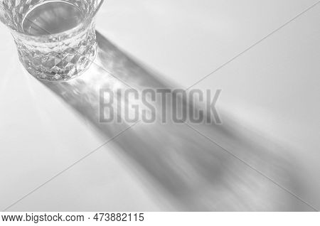 A Glass With Water And Sharp Shadows, Caustic Effect As Light Passes Through