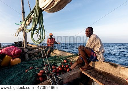 Dar Es Salaam, Tanzania - March 2023: Local Fishermen Are In The Process Of Fishing On An Old Boat.