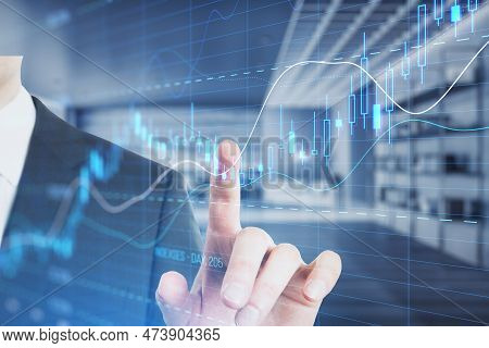 Close Up Of Businessman Hand Pointing At Glowing Candlestick Forex Chart With Index On Blurry Office