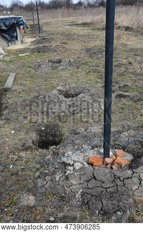Fence Post Installation. Fence Footings. Close Up On Concrete Footing Metal Building.