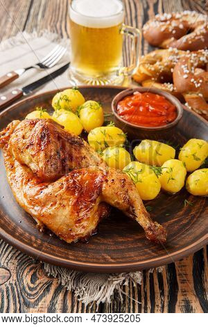 German Holiday Food Half Fried Chicken With Boiled Potatoes, Sauce, Beer And Pretzels Close-up On A 